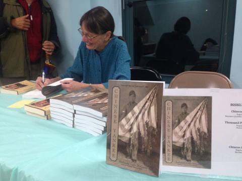 Ruthanne signing books at the Chinese Historical Society of New England